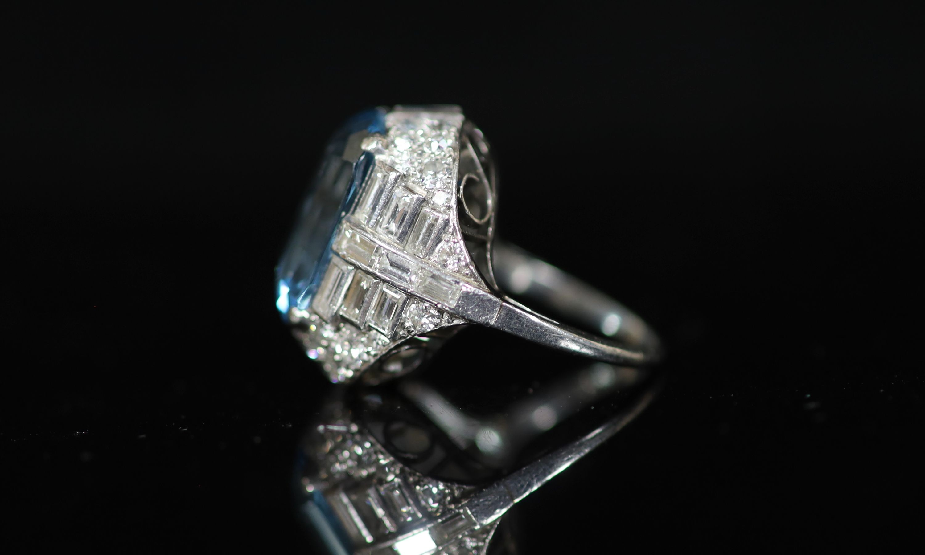 A 1930's/1940's platinum?, emerald cut aquamarine, round and baguette cut diamond set dress ring